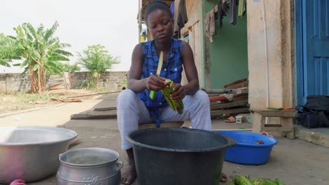 black african young woman cocking traditional ghana food called fufu