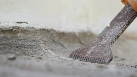 construction worker using a hammer to chip away at concrete