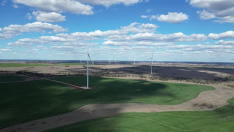 a newly constructed wind farm built on cattle grazing and cropping farmland producing green energy