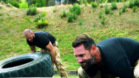 Military-men-lifting-a-big-tire-