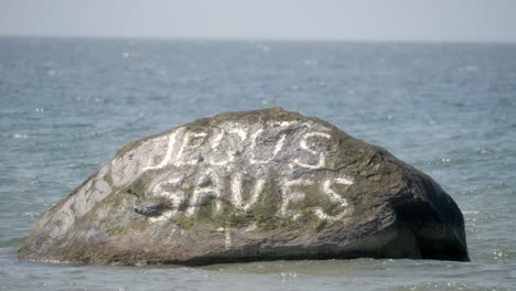 ocean graffiti, gospel statements, offshore remote rock, sacred stone