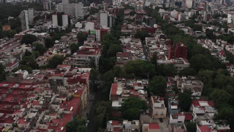 Suburbs-of-Mexico-city-with-skyline-in-horizon,-aerial-drone-view