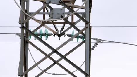 close up view of a transmission tower, aerial drone video