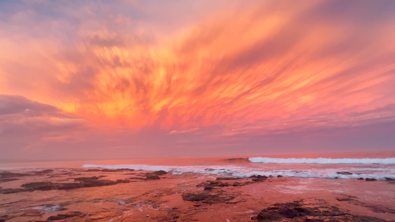 JBay Jefferey's Bay South Africa most stunning best ever incredible summer sunset thunderstorm clouds golden orange pink waves crash on coastline shore Supers Impossible boneyard surf slow pan left