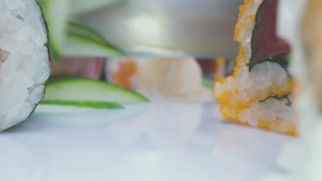 Crop-chef-chopping-cucumbers-for-sushi