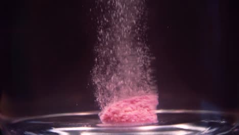 slowmotion shot of efervescent pill dissolving in water. bubbles going up. stable shot with the sony a7iii