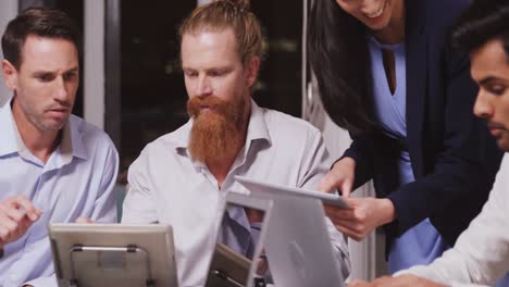 Business-people-discussing-over-digital-tablet