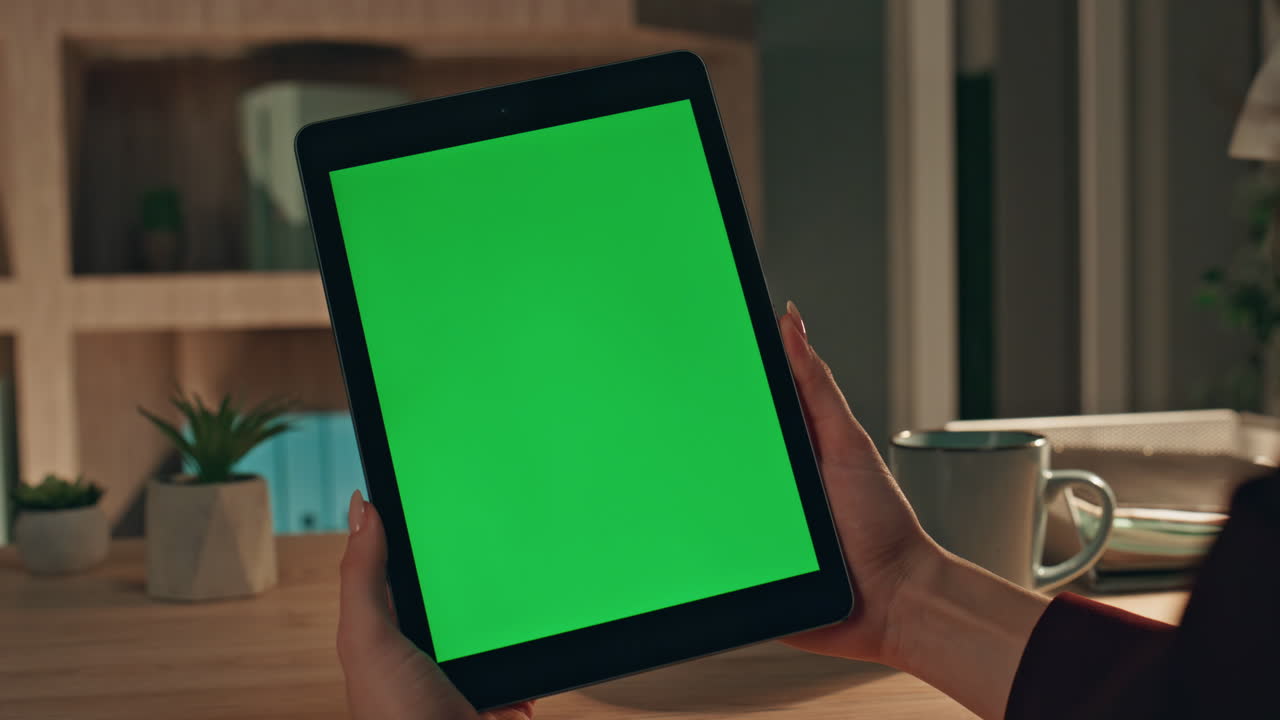 Remote employee browsing mockup tablet in home workplace close up. Unknown woman