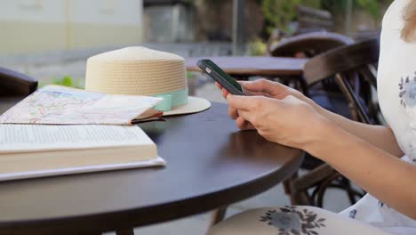 una mujer usando un teléfono inteligente en una cafetería.