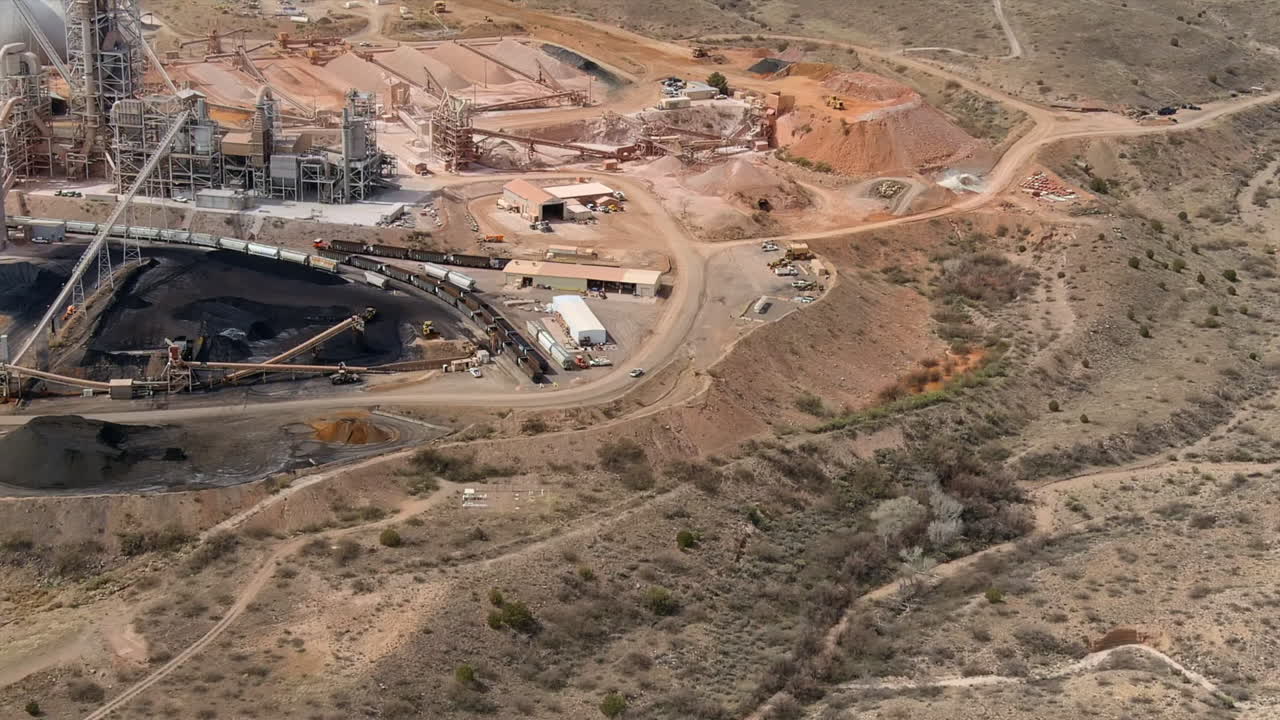 Large industrial factory with digging equipment, aerial view