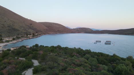 Vista-Aérea-De-La-Costa-épica-De-Porto-Palermo-Durante-La-Puesta-De-Sol,-Albania