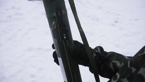 soldier holding a grenade launcher in winter