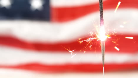 independence day text and a flag behind a sparkle for fourth of july.