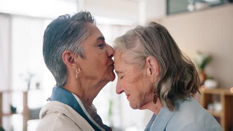 affectionate kiss between two senior women