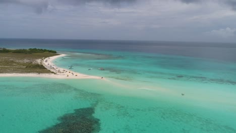 aerial approach tropical sandbank with people cross, cayo de agua caribbean destination