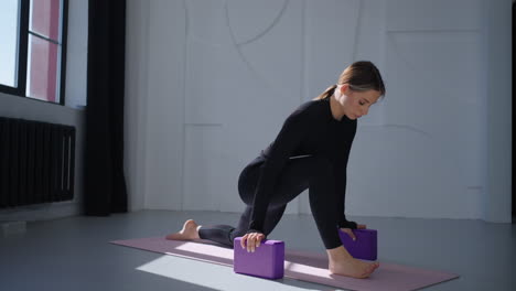 woman doing yoga stretching exercise on mat