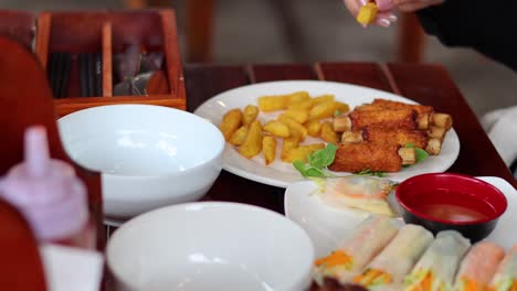 hands arranging sugarcane shrimp on a plate