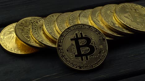 bitcoin coins on dark wooden background