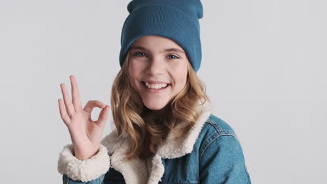 Teenage-Caucasian-girl-wearing-denim-jacket-and-gesturing.