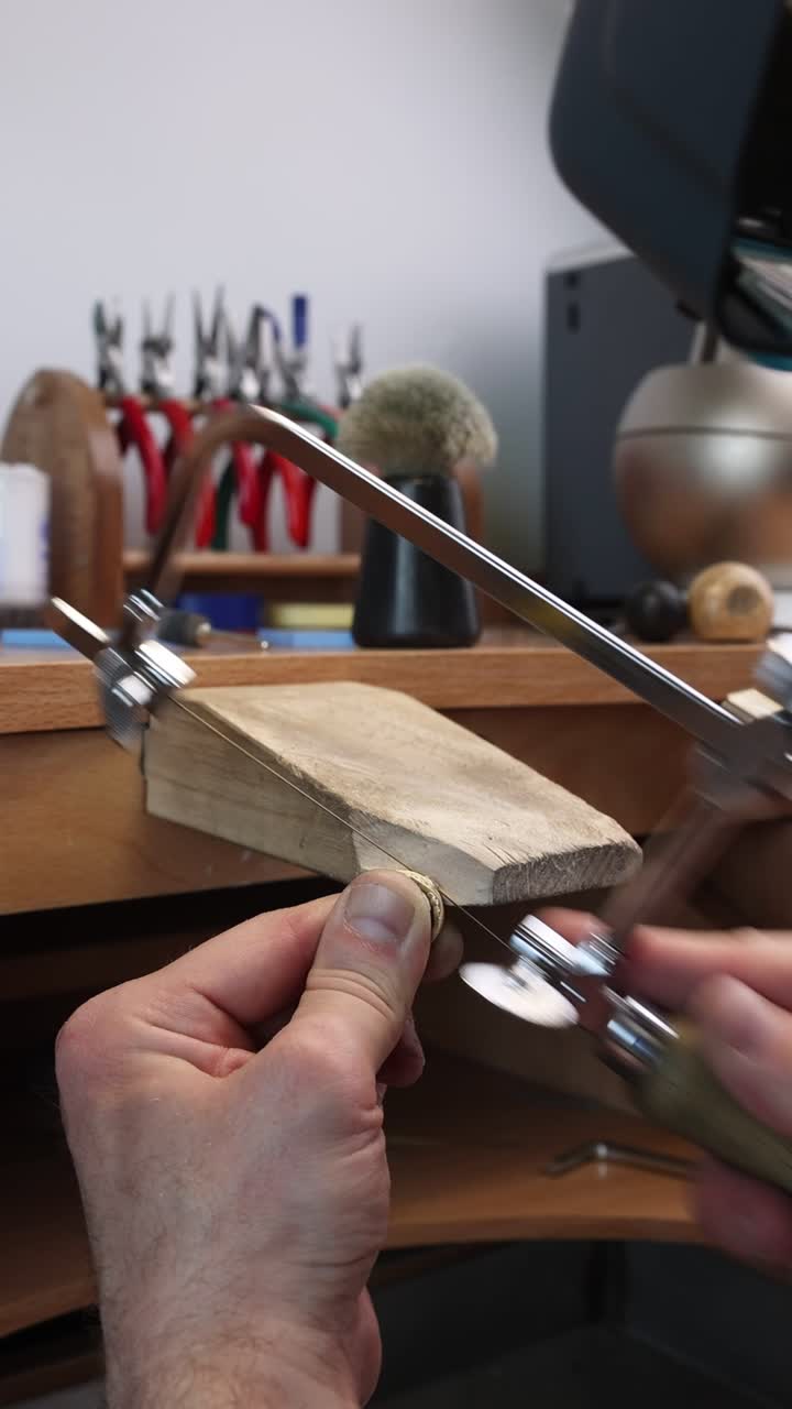 Close-up of a Jeweler Sawing a Metal Ring