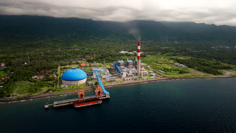 coal power plant on bali north coast with smokestack emitting gases, aerial