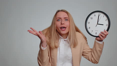 business woman with anxiety checking time on clock running late to work being in delay deadline