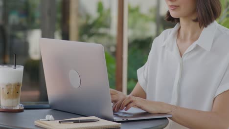 woman working on laptop in outdoor coffeeshop