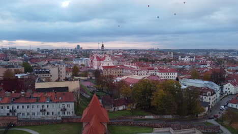 view from the bastion of hot air balloons in flight over old town of vilnius in lithuania with church of st