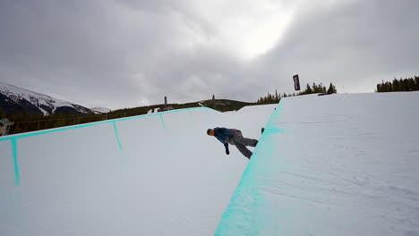 snowboarder half pipe huge air jump spin woodward copper mountain ski snowboard resort winter training olympics competition fresh snow vail aspen x games slow motion cinematic pan follow wide angle