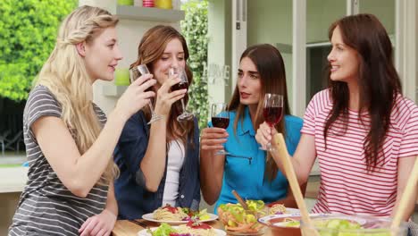 happy friends toasting with red wine