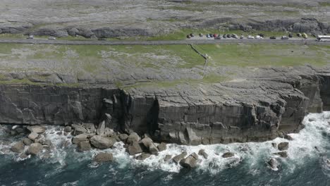 atlantic ocean waves smash into vertical stone cliff, the burren, irl