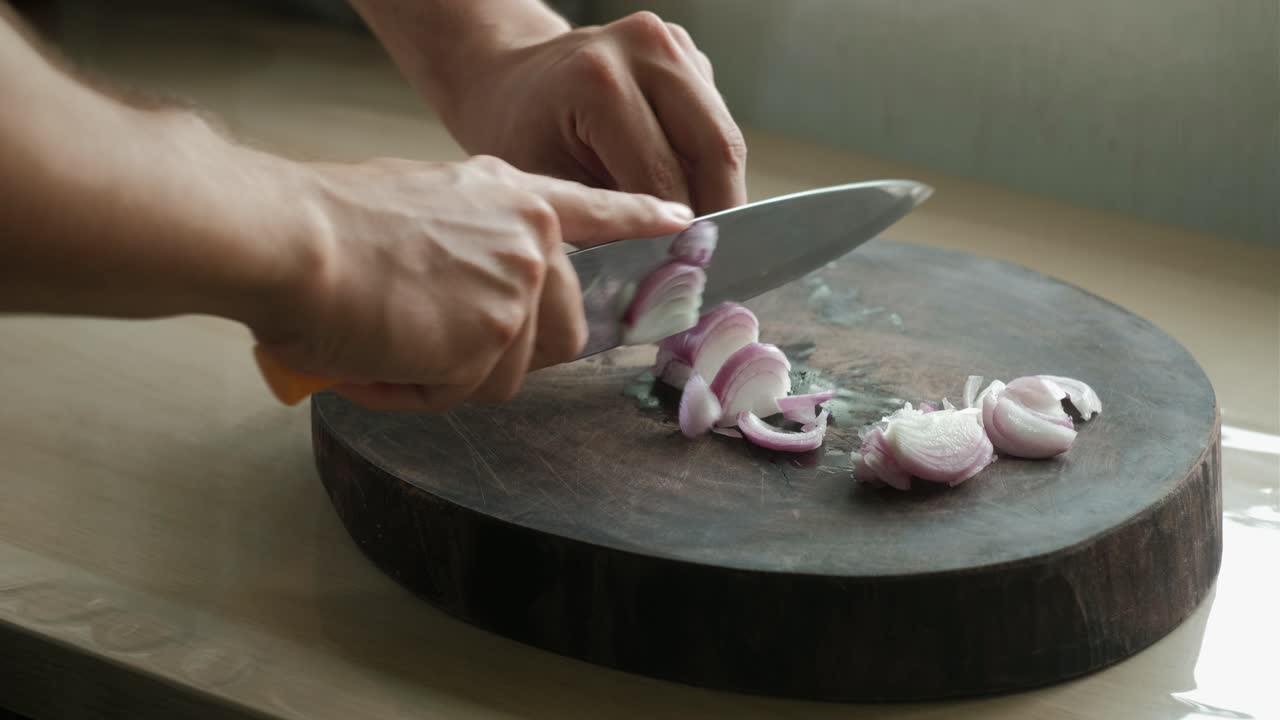 Chopping Red Onions On A Wooden Board. Close-up Shot