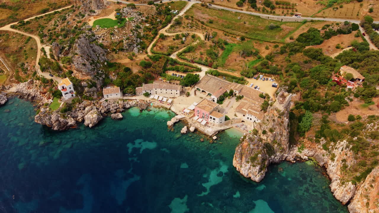 Tonnara di Scopello Museum And Faraglioni Rock Formations In Scopello, Trapani, Italy. Aerial Drone Shot