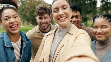 happy friends taking a selfie in a park