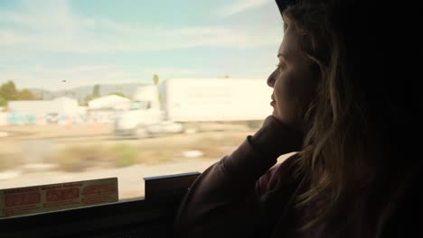 peaceful passenger, woman looking out window on train through southwestern usa