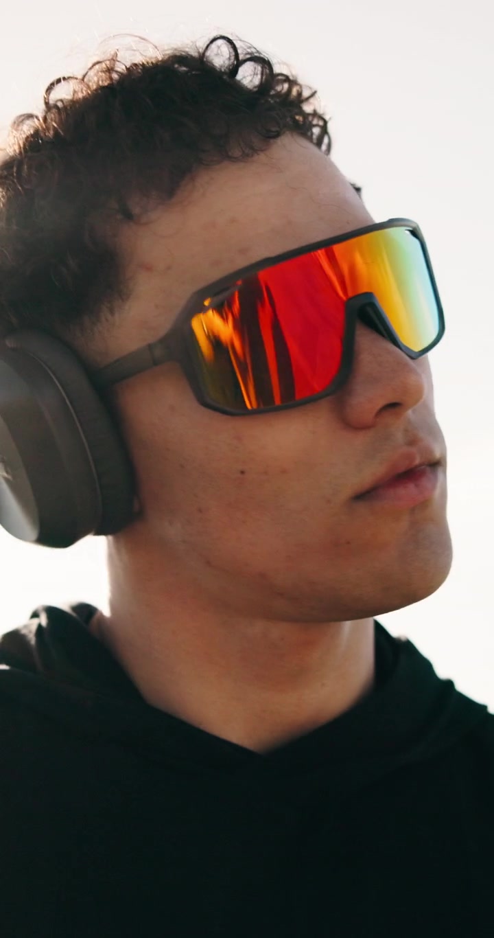Young Man Exercising Outdoors Wearing Headphones and Sport Sunglasses