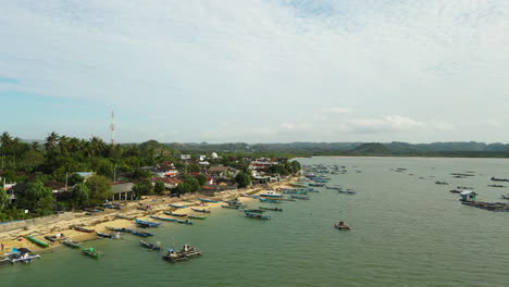 playa de la ciudad de gerupuk en lombok con muchos barcos tradicionales flotando en el agua