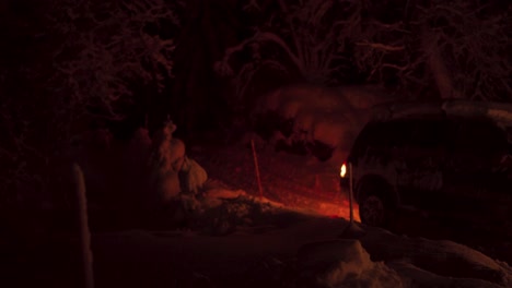 car driving in reverse on snowy countryside at night in norway