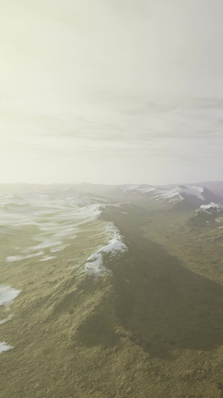Mountain landscape with snow and mist in wide view during daylight hours