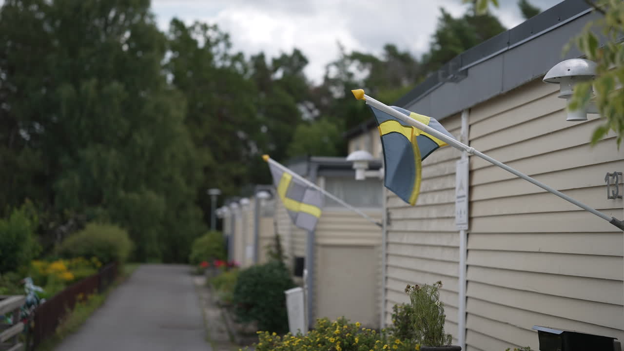 Swedish flag waving in the wind in Stockholm suburb