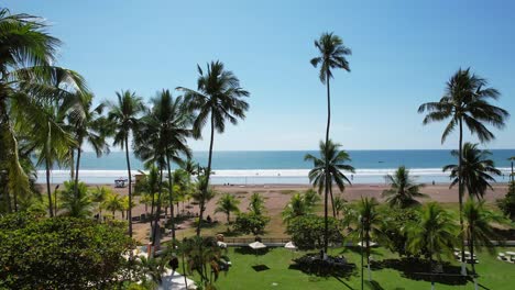 Aerial-images-of-the-beach-on-a-sunny-day,-Aerial-drone-images,-Beach-Jaco,-Puntarenas,-Costa-Rica,-Dolly-Inn