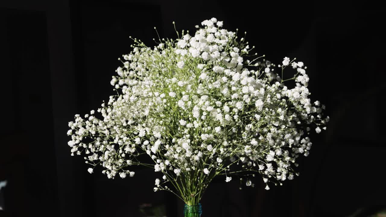 gypsophila graceful on table, white flowers close-up with a blurred background at home. Natural background for design or as texture. Summer plants.