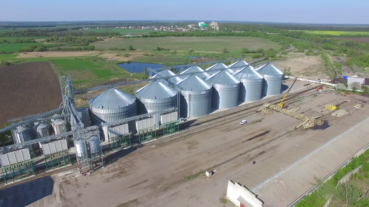 Aerial View Of Big Grain Elevators. Aerial view of grain elevators surrounded by green fields