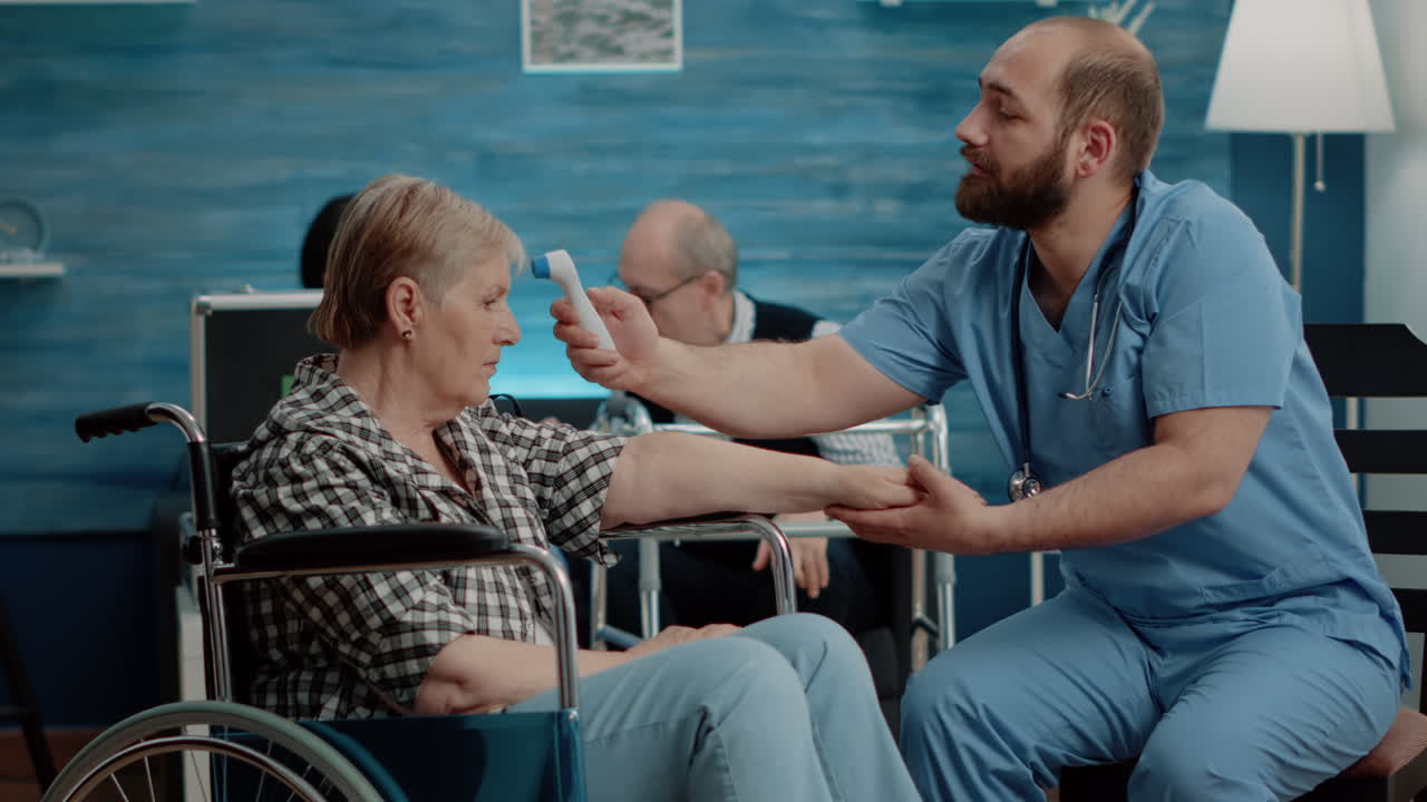 Medical assistant checking temperature of disabled woman