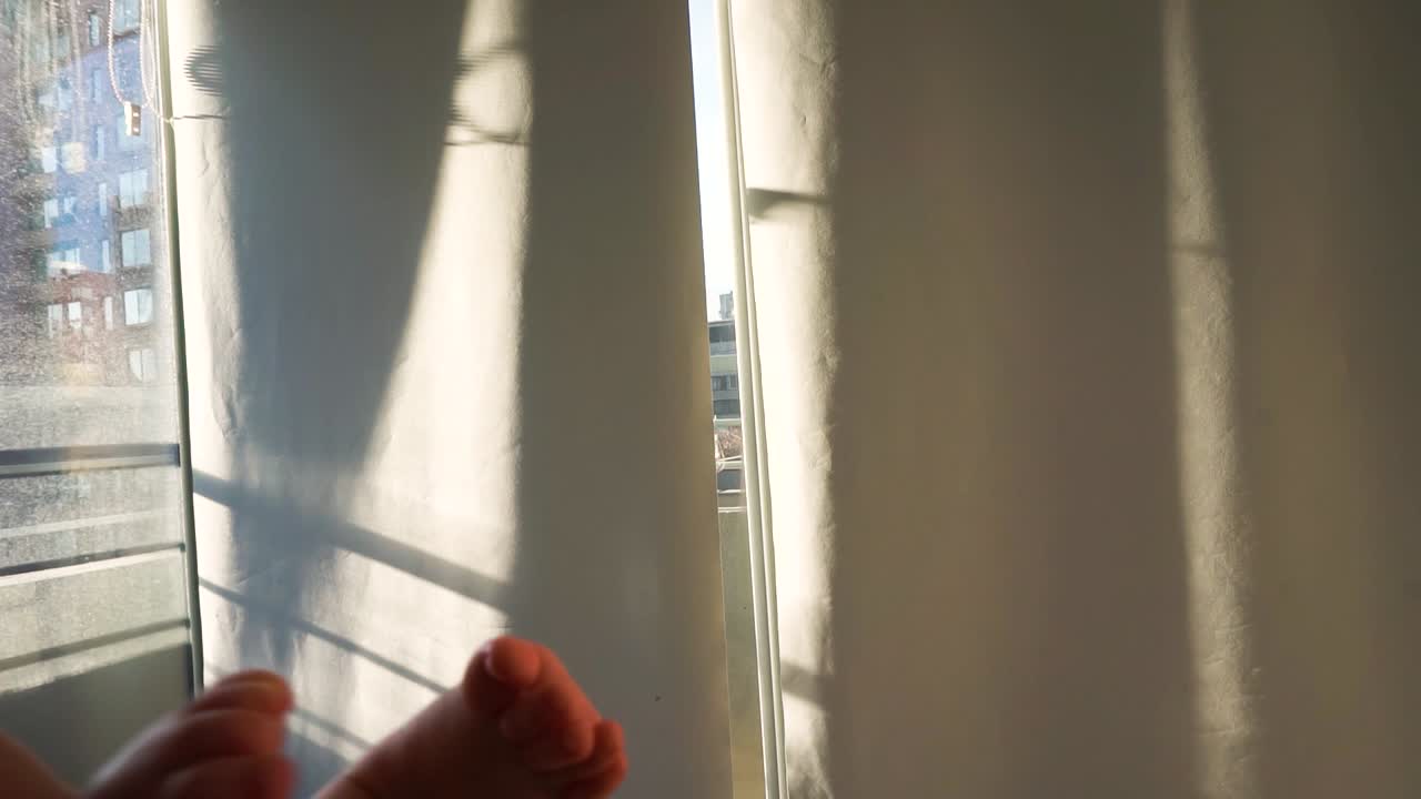 Handheld Shot of baby playing foots sunny winter morning after bath HD