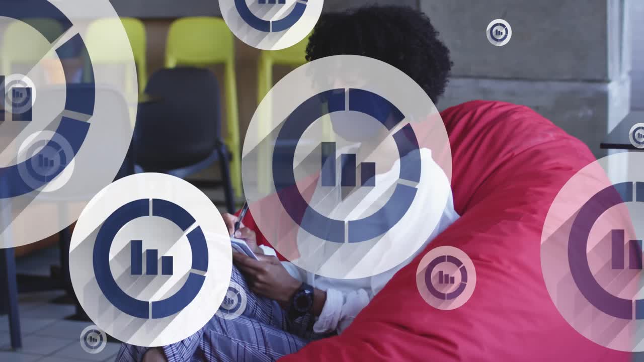 Digital icons floating against african american woman wearing face mask taking notes at office