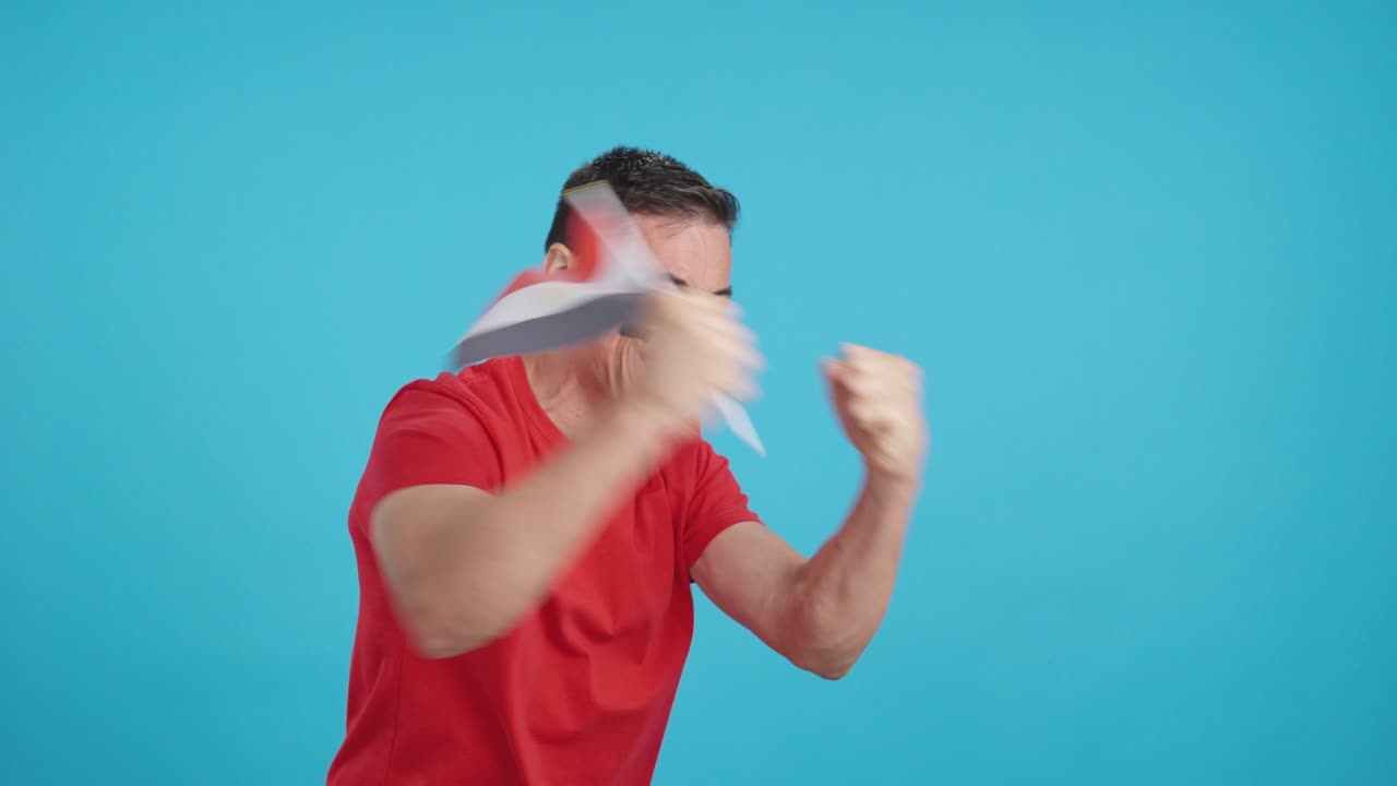 Man cheering for Egypt waving a national flag looking away
