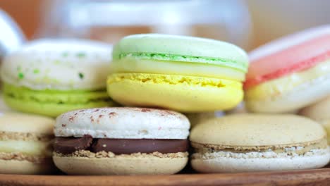 close-up of colorful macaron (macaroon) on the table with hot tea