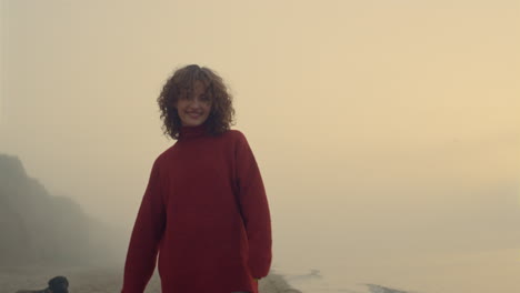 Happy-girl-looking-at-camera.-Fashionable-woman-posing-on-beach-at-sunrise