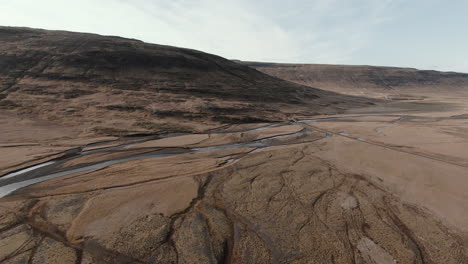 autumnal landscape with dry river patterns in ground